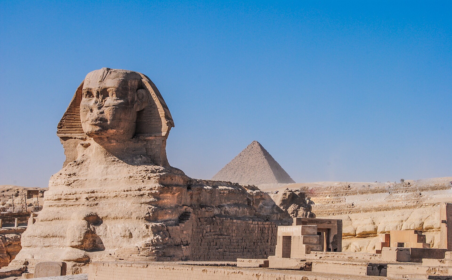The Great Sphinx of Giza with a pyramid behind it, part of the Mediterranean and Nile World Heritage of North Africa.